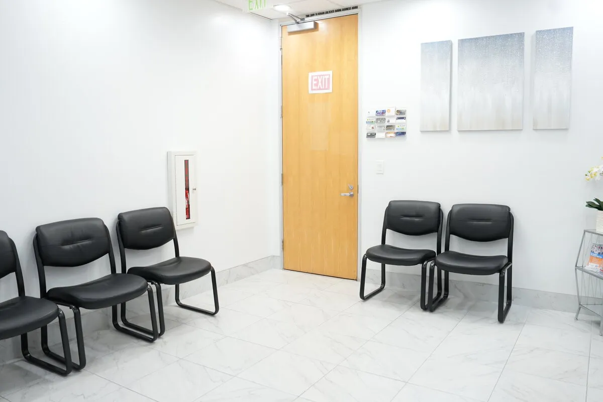 The waiting room, with seating along two walls and natural light